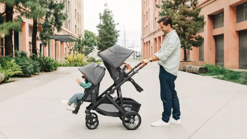 Parent with twins in the Toddler Seat and RumbleSeat V3