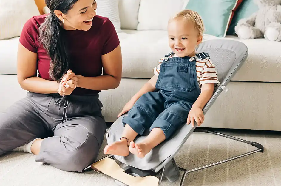 Smiling parent and child bouncing in Mira